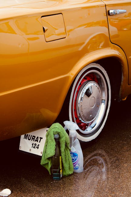 Detailed cleaning of a classic orange car wheel showcasing meticulous maintenance
